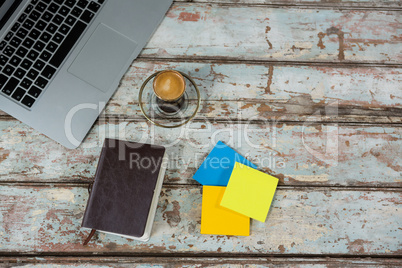 Laptop, sticky notes, and diary with cup of coffee