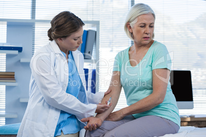 Doctor giving injection to patient