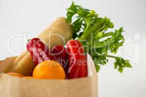 Fruits and vegetables in brown grocery bag