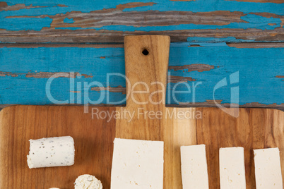 Variety of cheese arranged on chopping board