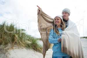 Happy mature couple pointing at view