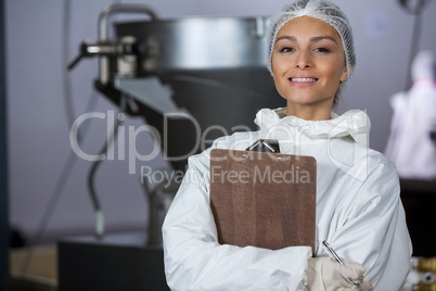 Female butcher holding clipboard