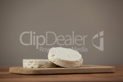 Slices of cheese on chopping board