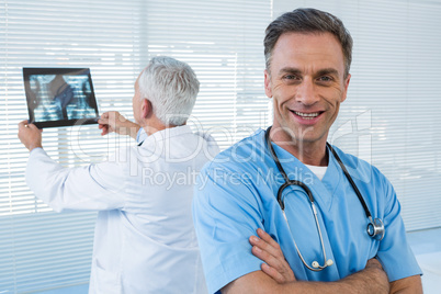 Portrait of surgeon standing with arms crossed