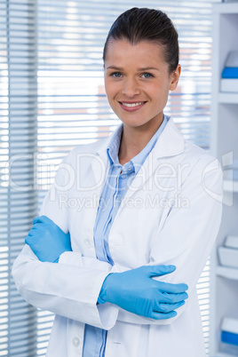 Portrait of a smiling female doctor standing with arms crossed
