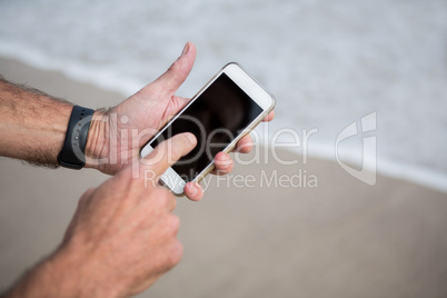 Close-up of mans hands using mobile phone