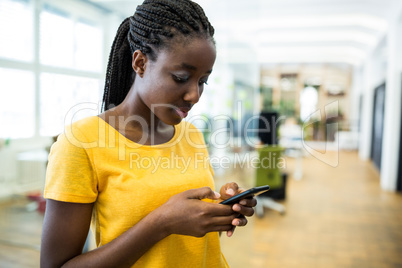 Woman text messaging on mobile phone