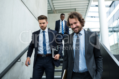 Group of businessmen climbing down stairs