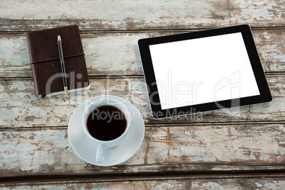 Digital tablet with cup of coffee and organiser