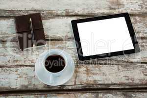 Digital tablet with cup of coffee and organiser