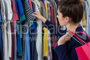 Woman choosing clothes in shop