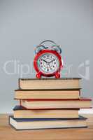 Alarm clock and stack of books