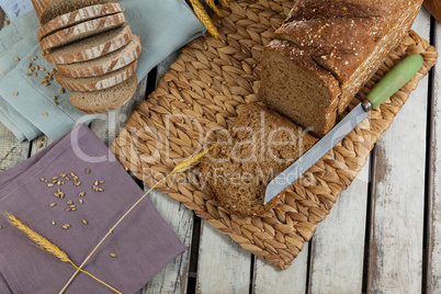 Sliced loaf of bread with knife