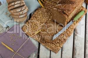 Sliced loaf of bread with knife