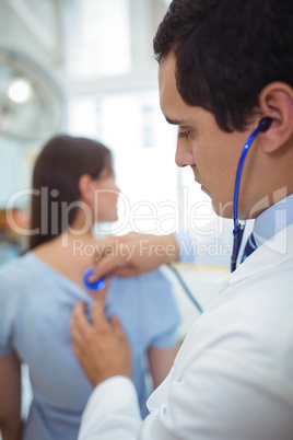 Doctor examining a female patient