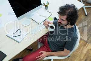 Business executive having coffee at his desk