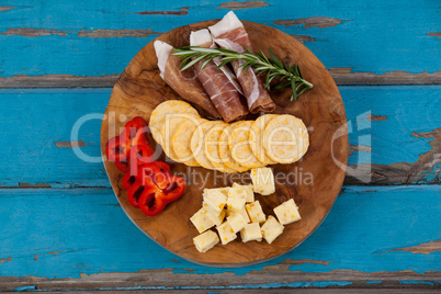 Cheese with knife on chopping board