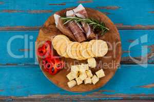 Cheese with knife on chopping board