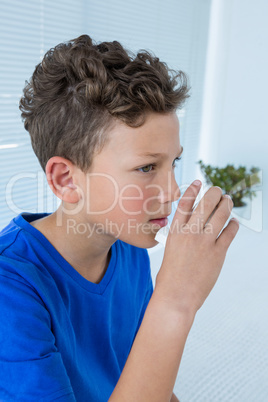 Boy using asthma pump