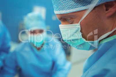 Male surgeon wearing surgical mask in operation theater