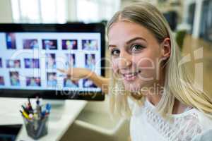 Female business executive pointing at computer screen