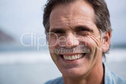 Close-up of smiling man on beach