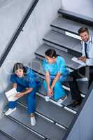 Nurses and doctor talking on stairs