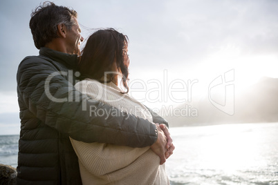 Romantic couple embracing each other on beach