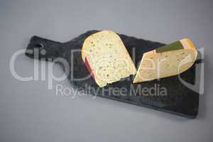 Slice of cheese on chopping board