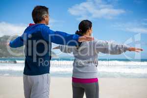 Couple performing stretching exercise