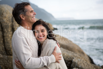 Romantic couple embracing each other on beach