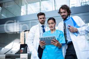 Doctors and nurse looking at digital tablet