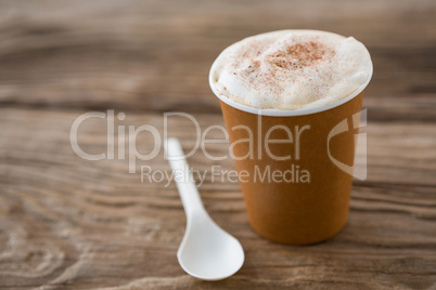 Coffee with spoon on wooden table