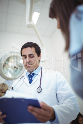 Doctor checking patient report