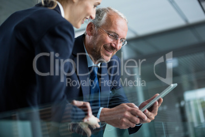 Businessman with colleague using digital tablet