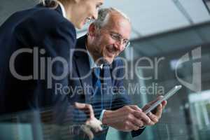 Businessman with colleague using digital tablet