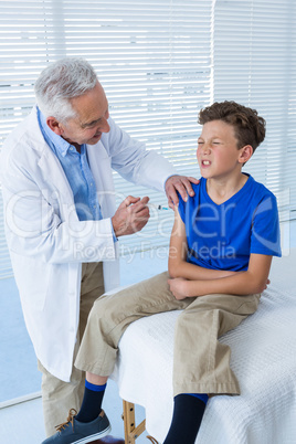 Doctor giving an injection to the patient