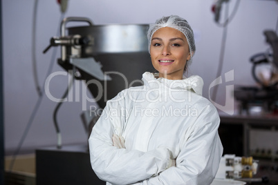 Female butcher standing with arms crossed