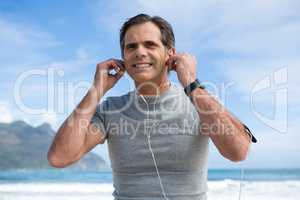Smiling man listening to music on headphones