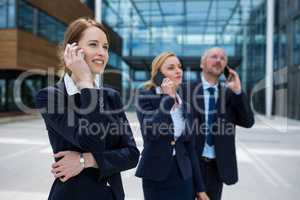 Businesspeople talking on mobile phones