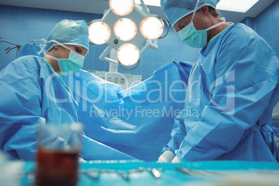 Team of surgeons performing operation in operation theater