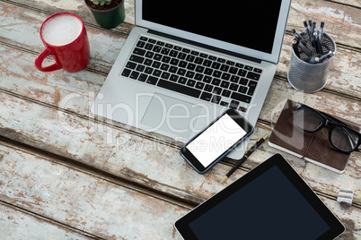 Laptop with digital table, mobile phone and coffee