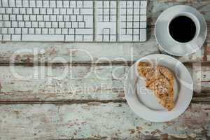 Keyboard, coffee cup and cookies