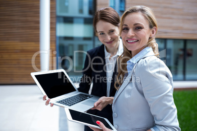 Businesswomen using laptop and digital tablet