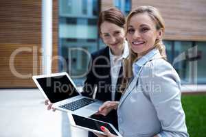 Businesswomen using laptop and digital tablet