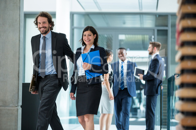 Businesswoman walking with colleague