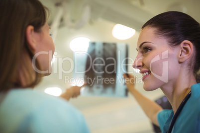 Female nurse discussing x-ray report with patient