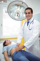 Doctor examining the stomach of a female patient