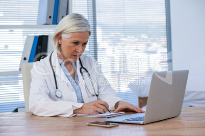 Female doctor working at her desk