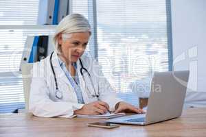 Female doctor working at her desk